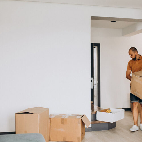 Young man moving into new house